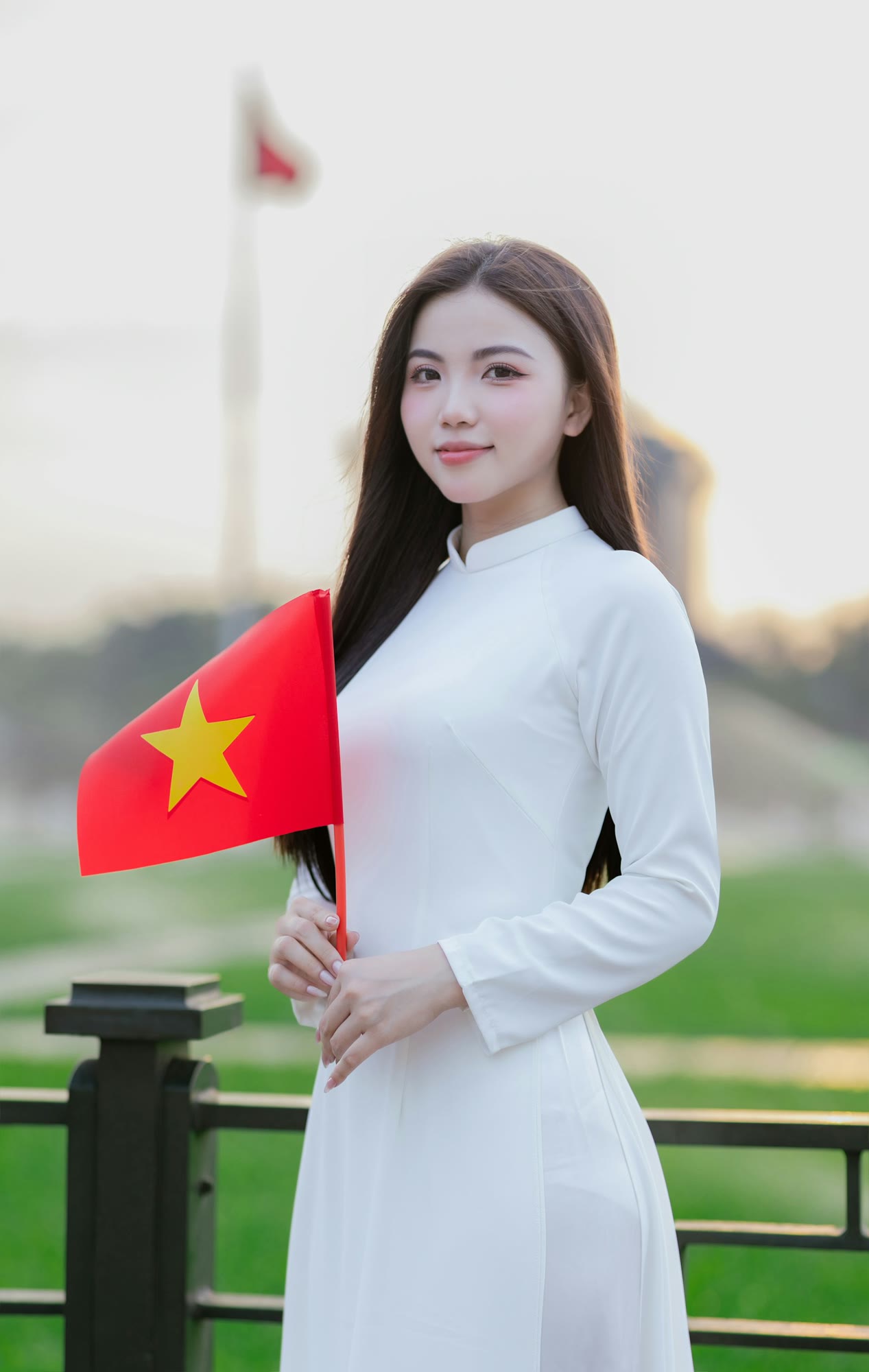 A woman in vietnam holds a flag.